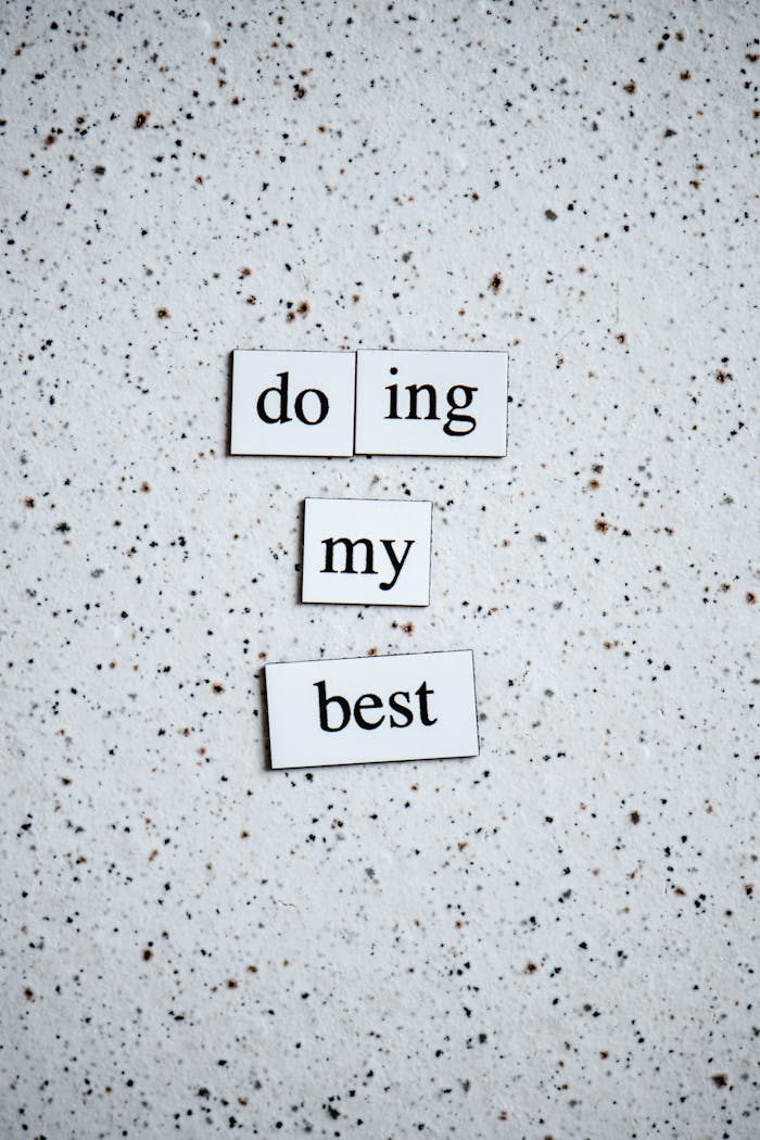 Black and white inspirational quote 'doing my best' on a speckled surface.